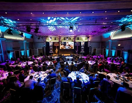 Corporate event with people sitting at tables